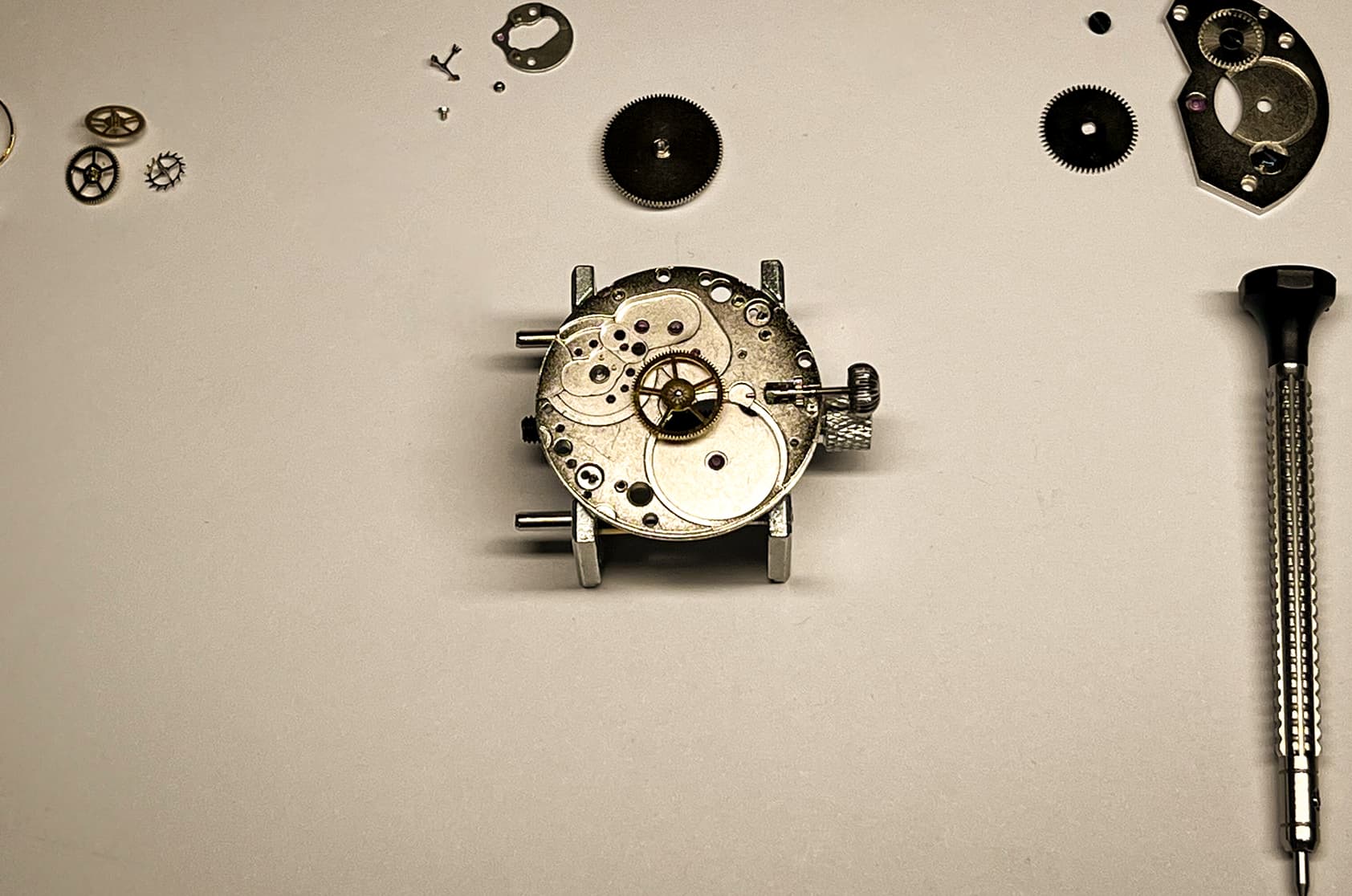 Watch movement and repair tools on a work surface
